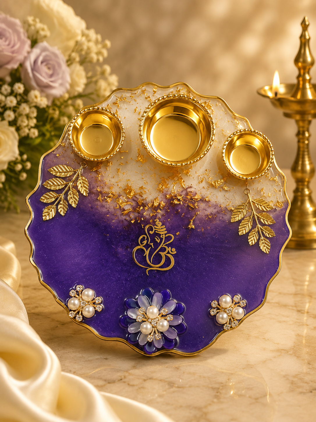 Handmade 6 inch violet and gold resin pooja thali with Ganesha motif, three gold katoris and pearl flowers