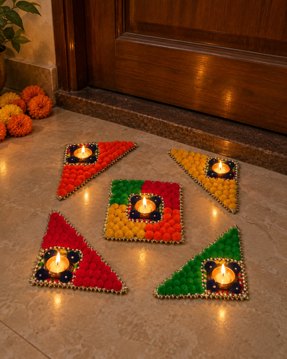 Reusable rangoli set with five lit tealights at a home entrance on Diwali night