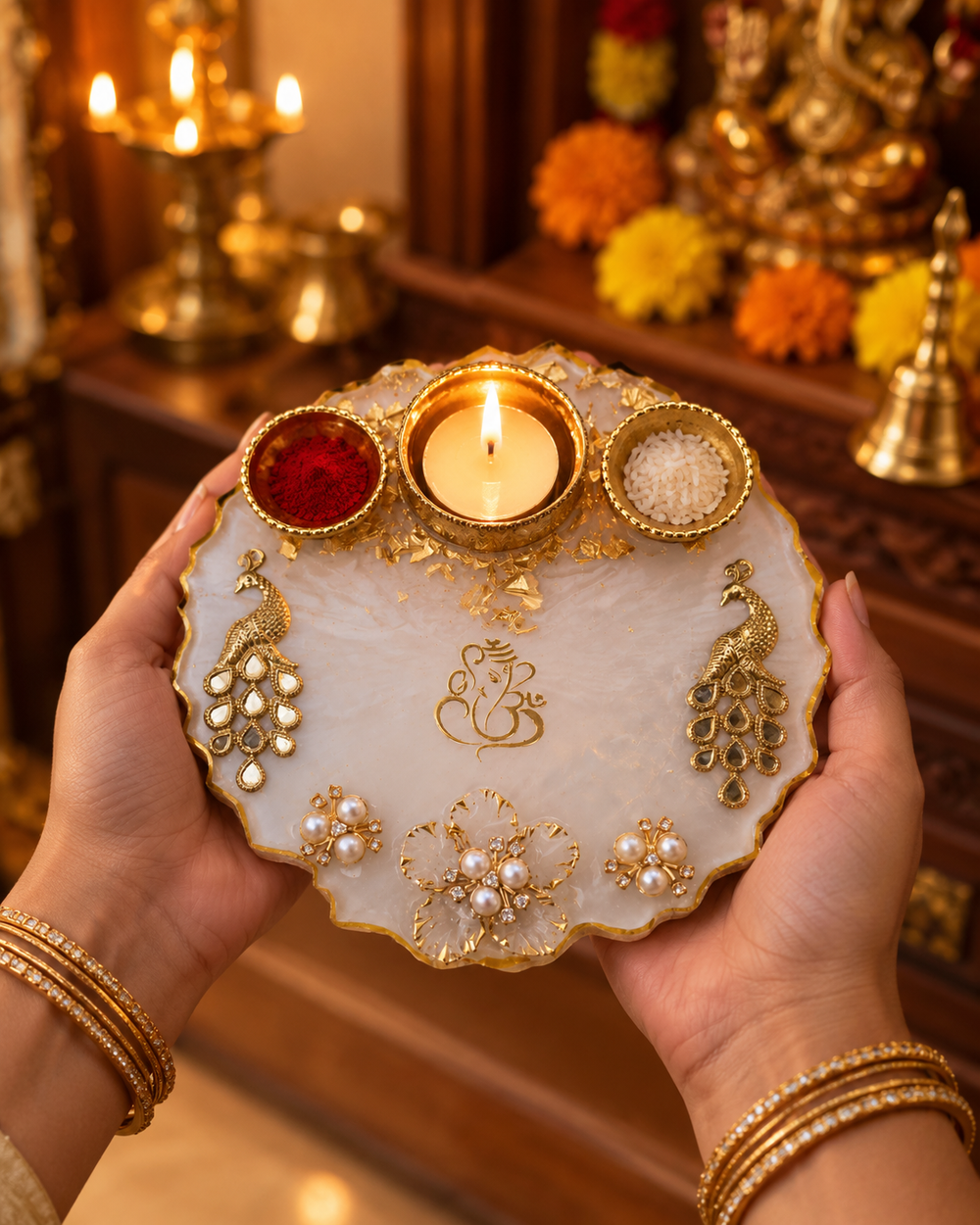 Hands holding the 6-inch ivory peacock Ganesha pooja thali during aarti