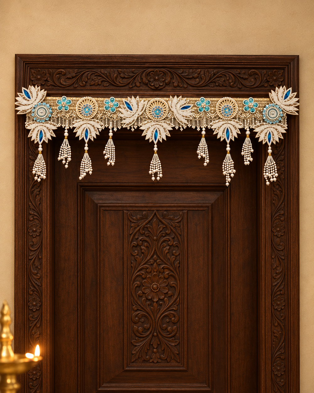 Pearl Lotus Toran on a carved wooden single door: handmade ivory pearl toran with lotus motifs, blue accents and pearl tassels