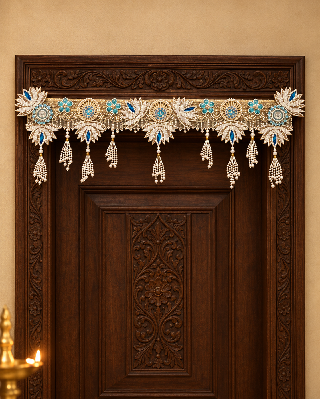 Pearl Lotus Toran on a carved wooden single door: handmade ivory pearl toran with lotus motifs, blue accents and pearl tassels