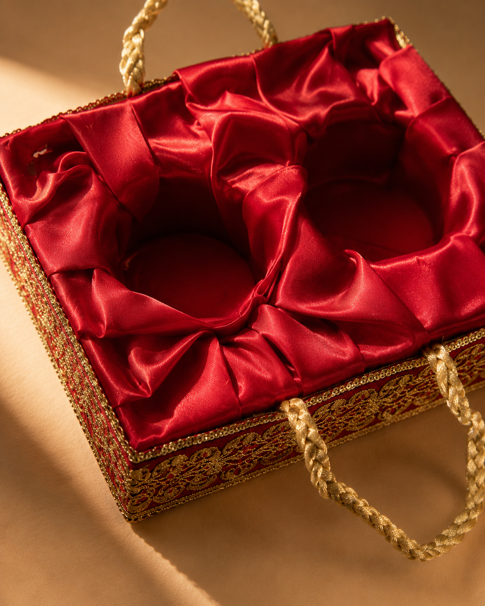 Close-up of the hand-pleated red satin lining and gold sequin trim inside the Giftra dry fruit gift basket