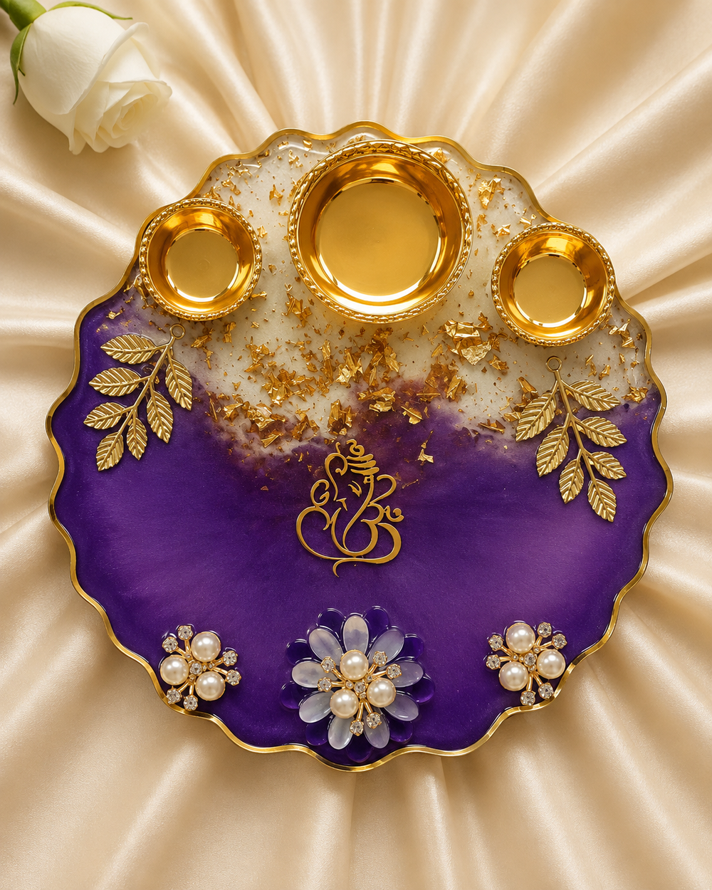 Top view of the 6 inch resin aarti thali showing gold Ganesha calligraphy, gold leaf sprigs and three gold katoris